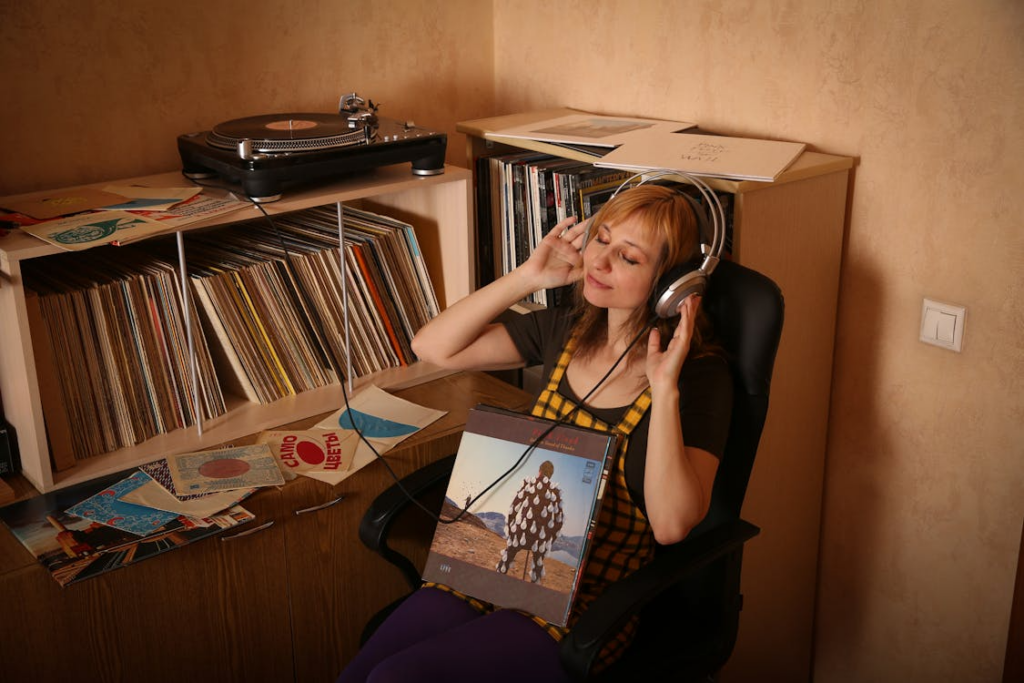 Physical media comeback shown through vinyl records, headphones, and a turntable setup.