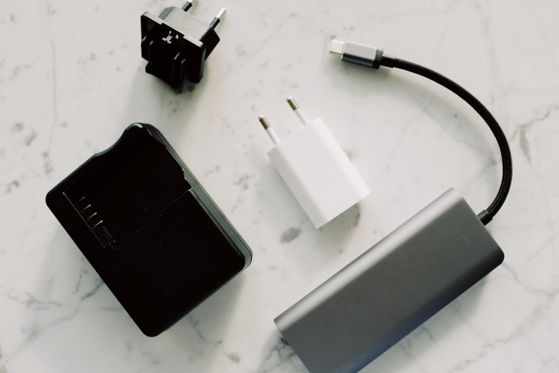 Everyday product improvements shown through modern chargers, a USB-C cable, and a portable power bank.