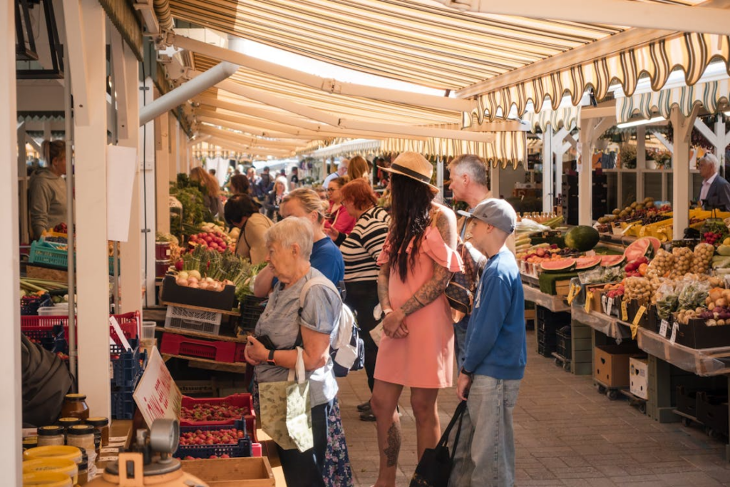 Farmers market crowd illustrating local community events making a comeback.