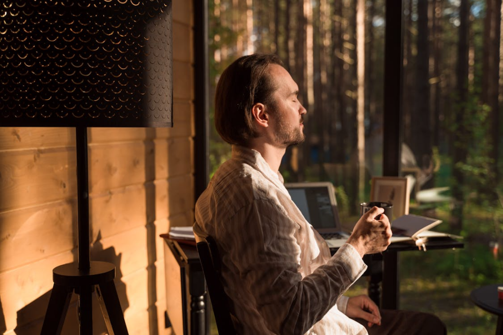 Short getaways for stress relief shown through a quiet cabin stay with coffee and forest views.