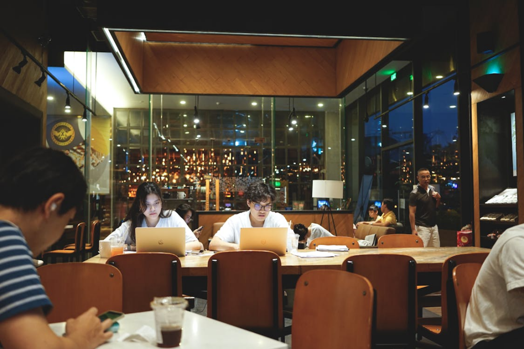 Third places for community shown through people working and gathering in a warm café.
