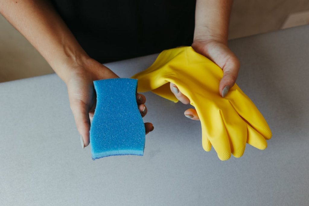 Household items to replace regularly shown through a sponge and cleaning gloves.