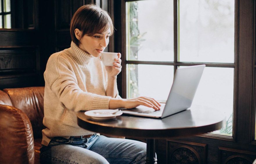 Redefining success in your 30s through a calm work moment with coffee and a laptop.